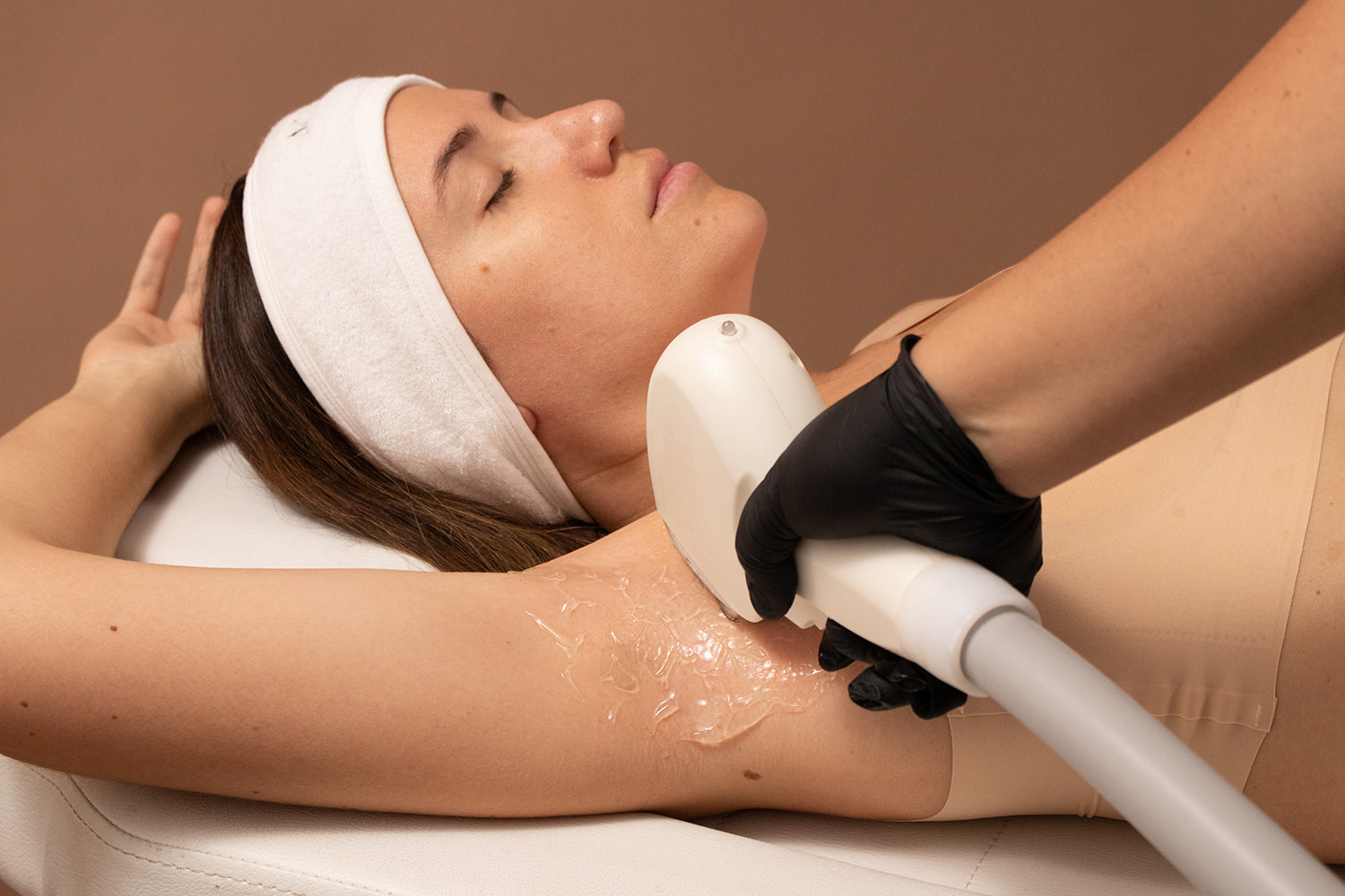 A person receiving laser hair removal on their underarm.