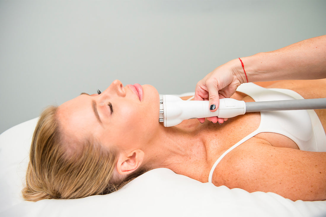 A woman receiving a cosmetic treatment on her face. 